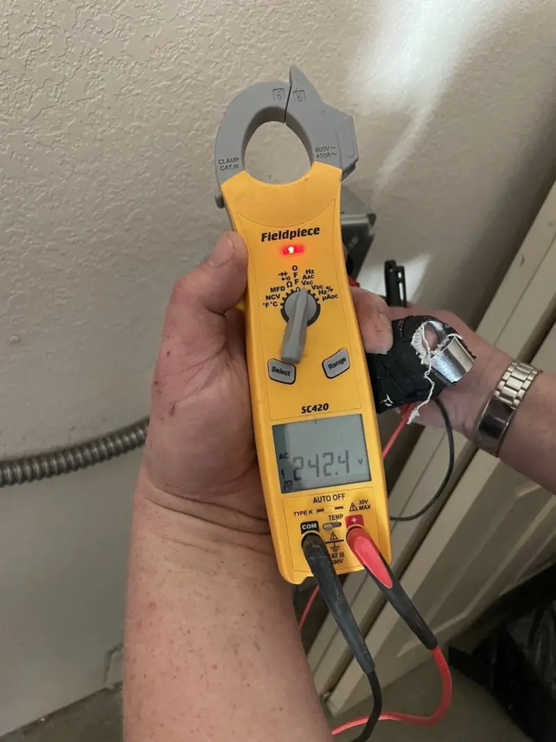Voltage testing with clamp meter during Electrical Installation Services in Franconia